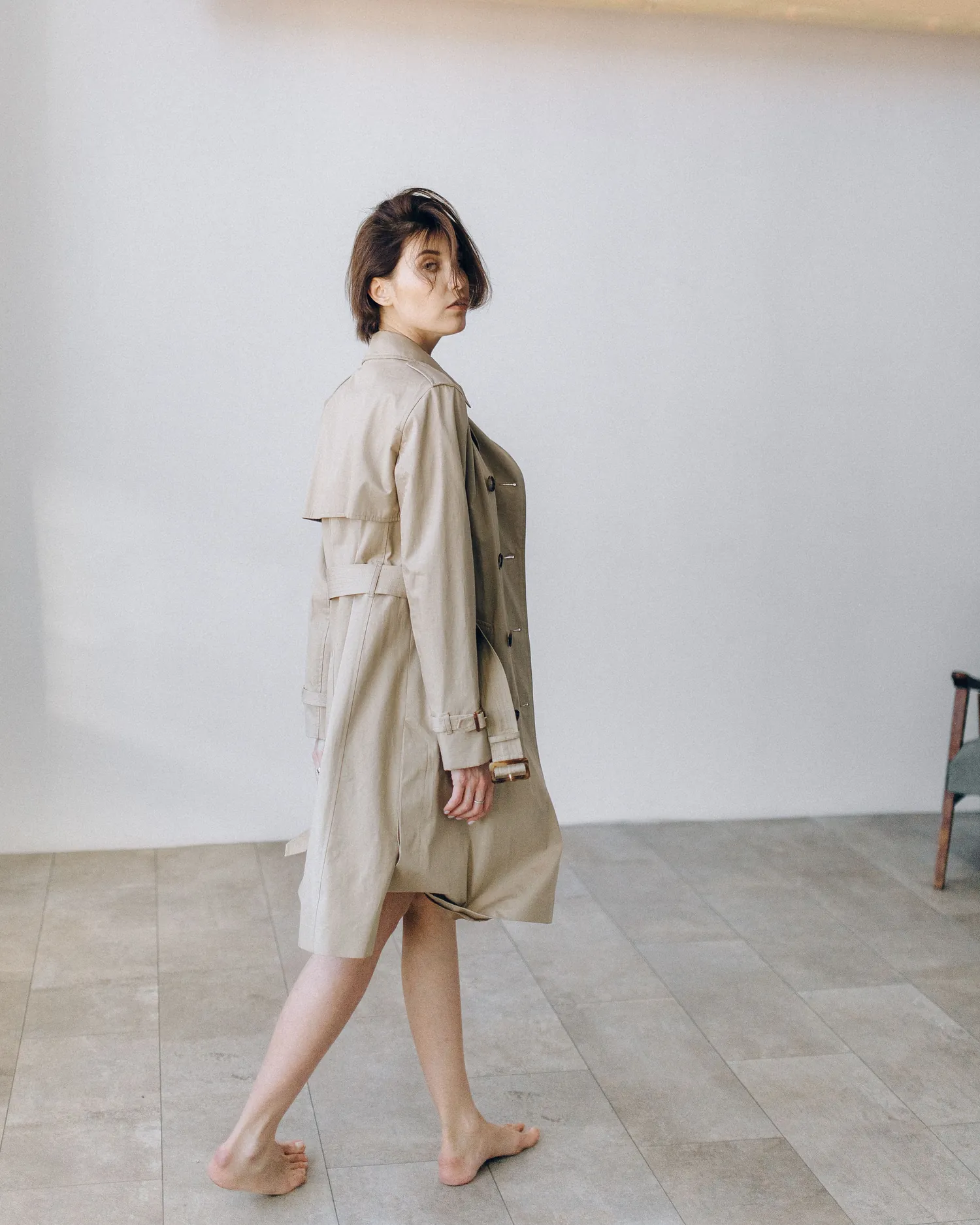The Long Coat — Model walking in a sand linen long coat, photographed full length