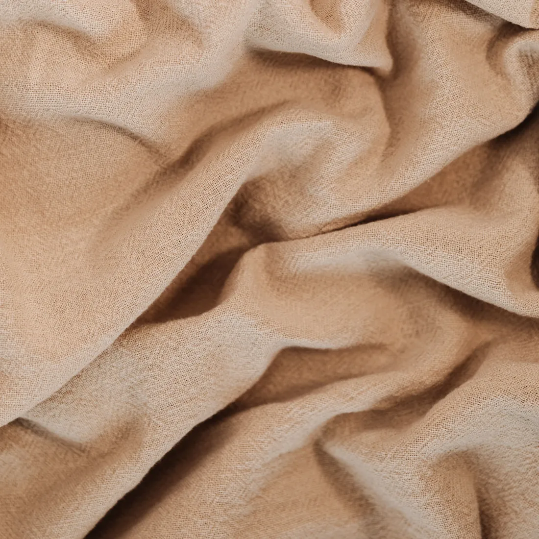 Close study of sand-coloured heavy linen in soft folds